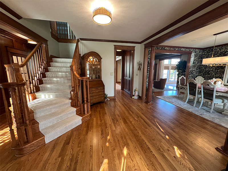 Gorgeous hardwood flooring entryway and wooden staircase